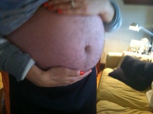 My wife's belly didn't get bigger than mine until her third trimester...